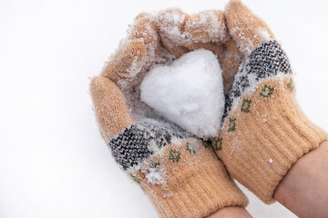 snow heart in hands. selective focus.