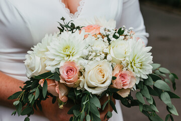 The bridal bouquet held in the bride's hands during the wedding