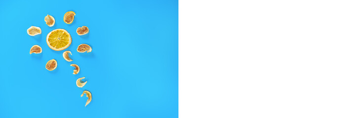 Flower of dried oranges and lemons on blue background. Banner.