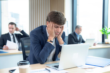 Young Asian businessman tired from work.