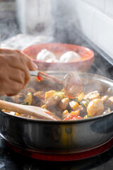 hand of person, removing food from pan

