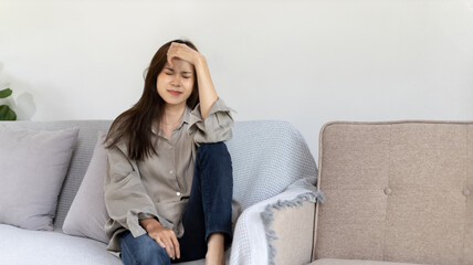 Obraz premium Stressed woman holding her temples with severe problems in her life, Family problems, Pressure from work, Poor financial, Despair in life, discouraged and deeply saddened, Panic attacks.