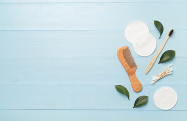Flat lay with natural biodegradable accessories on wooden background, top view