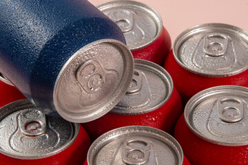 Obraz premium Cold red soda cans with a blue one for conceptual use