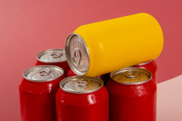 Cold red soda cans with a yellow one for conceptual use