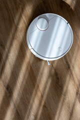 Vacuum Robot cleaning at home. Robot vacuum cleaner in the modern home. Smart cleaning technology