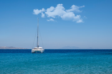 White sailing yacht anchoring in open ocean