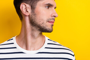 Obraz premium Close up cropped profile photo of serious nice young man look empty space isolated on yellow color background