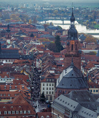 Naklejka premium Birds eye view of busy pedestrian streets of Heidelberg's Old Town with churches, red roofs and the river Nectar. 