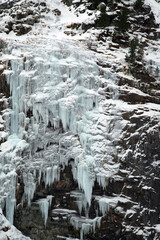 beautiful frozen waterfalls in winter in the alps, the hohe tauern national park in austria, at a cold winter day