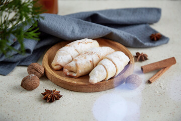Seasonal Christmas food - crescent powder bagels, walnuts, star anise. Cozy atmosperic home
