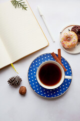 Mockup notepad with coffee cup, doughnut, decorations in home office. New year resolution, new start and list of goals concept