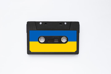 Magnetic old tape cassette for audio painted in the color of the ukrainian flag isolated on a white background