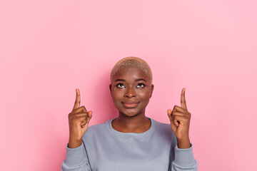 Portrait of charming nice lady look direct fingers up empty space isolated on pink color background