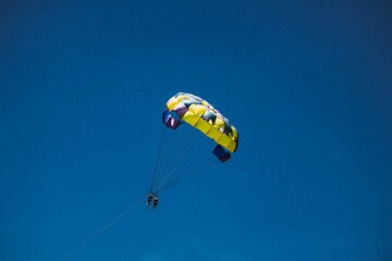 Man with parachute flying in the sky