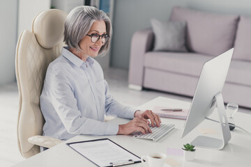 Profile portrait of clever experienced lawyer lady sit chair keyboard write email communicate colleagues modern office indoors