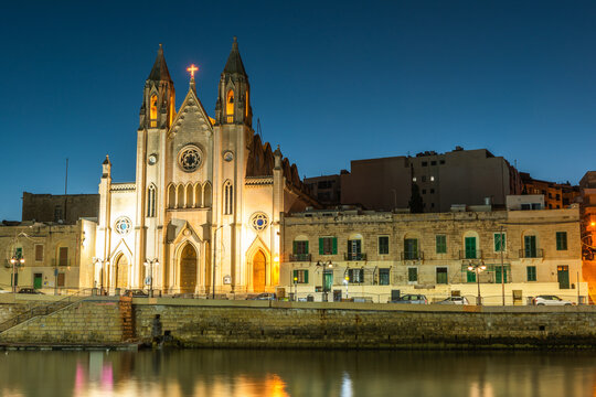 Illuminated Balluta parish church in Balluta bay, Malta