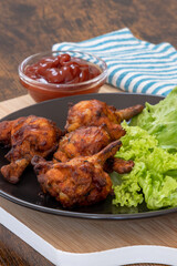 pilons de poulet grillé et ketchup sur une table	