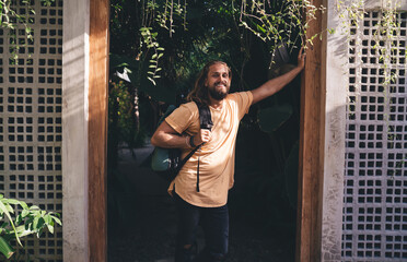 Smiling man with backpack on terrace