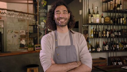 Portrait of cheerful businessman crossing arms and looking to camera, standing at his new Bar-Restaurant.