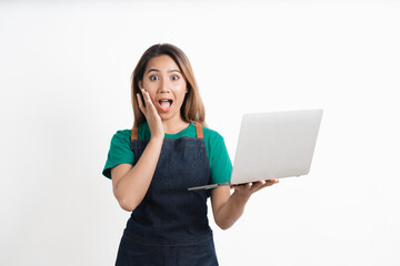 Young Asian business owners are excited by the good news while playing on computer laptop isolate on white background.