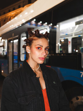 Trendy woman with bantu knots standing near bus