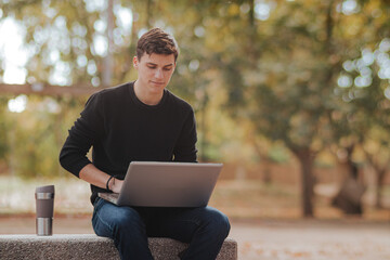 Man working on laptop in park
