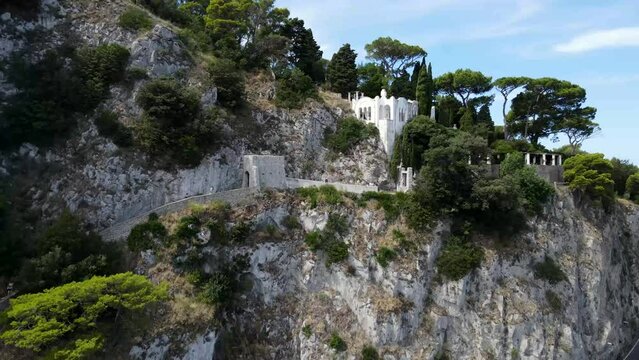Fly backwards to reveal Villa San Michele and the Phoenician Steps, with a highway running along the mountain