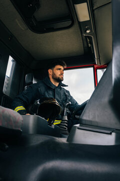 Male firefighter in fire engine