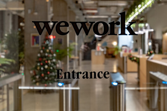wework lettering on the glass door at night