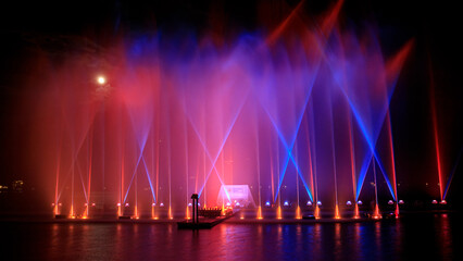 Naklejka na ściany i meble Beautiful fountain with colorful lights 
