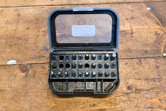 Box of hex bits standing on wooden bench in workshop