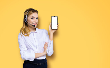 Customer support phone operator in headset holding showing smartphone cell phone mobile with white...