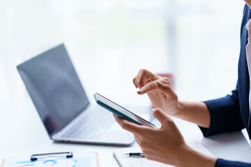 Woman using smartphone play social media application and conduct mobile banking.