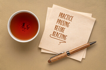 practice pausing before reacting - inspirational note on a napkin with a cup of tea, communication and personal development concept