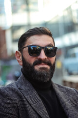 brutal bearded middle aged man in sunglasses