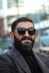Obraz premium brutal bearded middle aged man in sunglasses