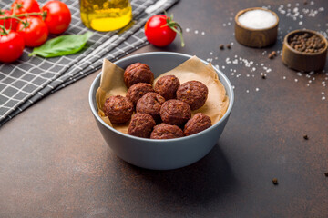 falafel balls in the dish on dark brown table