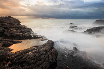 Sea wave on long exposure during sunset on the seashore