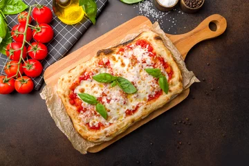 Foto op Plexiglas margarita pizza at the Rome dough, pinsa, on dark brown table top view © Алиса Королевская