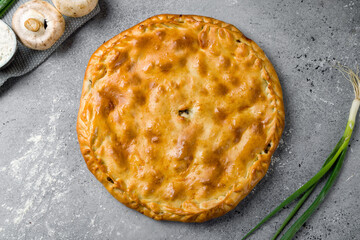 Ossetian pie with meat on grey table top view