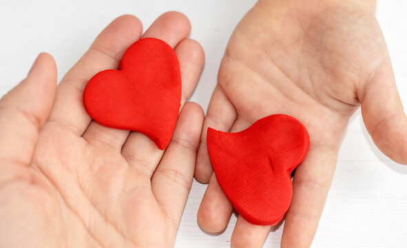 plasticine clay red color heart shape in kid woman mother son hands palm.diy do it yourself activities valentines love february 14th day back to school creative.modeling clay imagination development