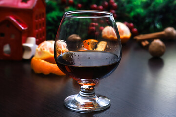 A glass of cognac on the Christmas table. Close-up