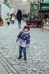 little girl grimacing outdoors in cold weather