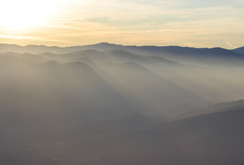 silhouettes of mountains in a haze in good weather