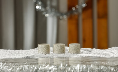 Pedestal on the table with snow in a Christmas mood and free space