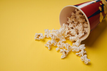 Popcorn snack in a cup on a yellow background
