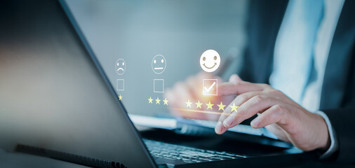 Customer service and Satisfaction concept. Business people are touching the virtual screen on the happy Smiley face icon to give satisfaction in service. rating very impressed. evaluation. Customer.