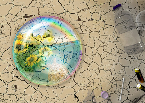 water drop with reflected images on cracked earth background