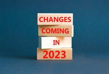 Changes coming in 2023 symbol. Concept word Changes coming in 2023 on wooden blocks. Beautiful grey...